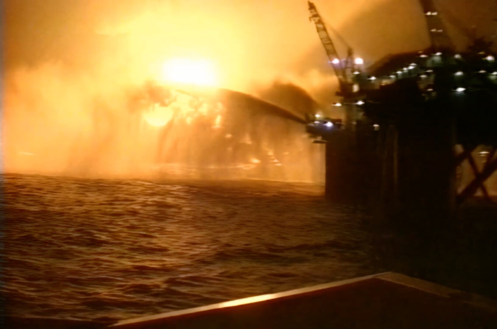 Piper Alpha disaster footage 6th July 1988 view of the Tharos fire monitors trained on the Piper Alpha platform